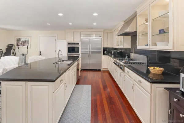 a kitchen with a stove and a white cabinets