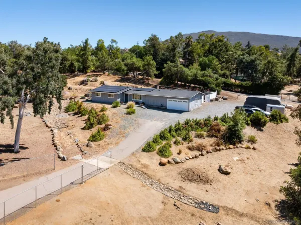 an aerial view of residential houses with outdoor space