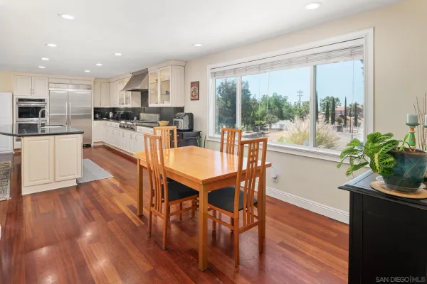 a dining room with furniture and wooden floor
