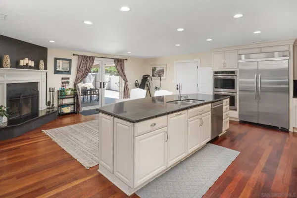 a kitchen with stainless steel appliances granite countertop a stove refrigerator and cabinets