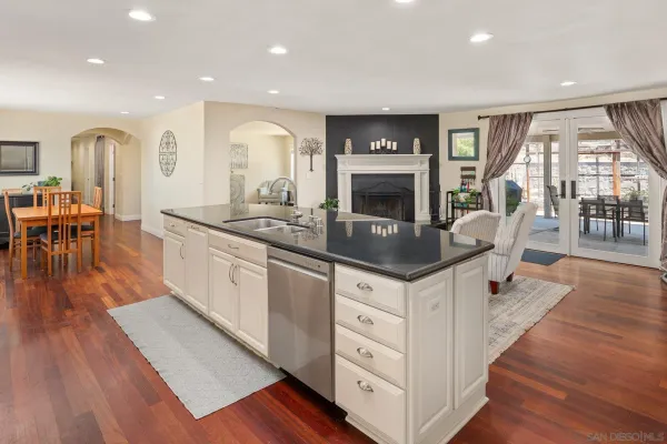 a kitchen with stainless steel appliances granite countertop a stove and a wooden floors