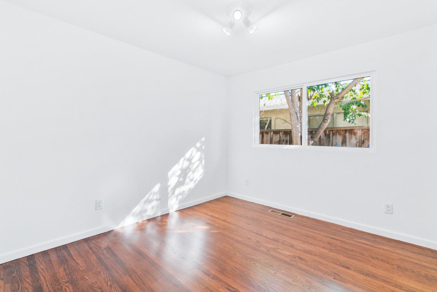2167 Violet Way Campbell, CA 95008 - Photo 17 of 42 an empty room with wooden floor and windows
