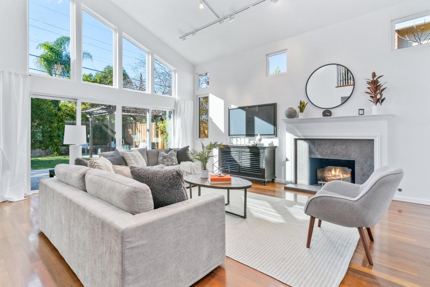 2167 Violet Way Campbell, CA 95008 - Photo 7 of 42 a living room with furniture a fireplace and a floor to ceiling window