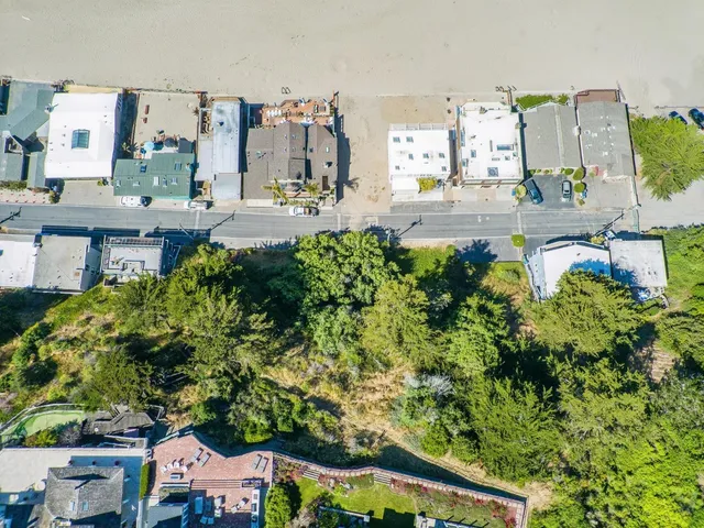 an aerial view of a residential houses with outdoor space