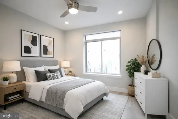 a bedroom with bed and a large window