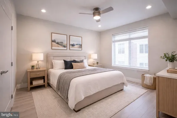 a bedroom with bed and a chandelier