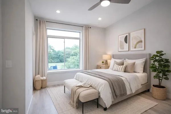 a bedroom with a bed and a large window