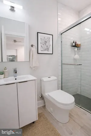 a bathroom with a toilet sink and shower