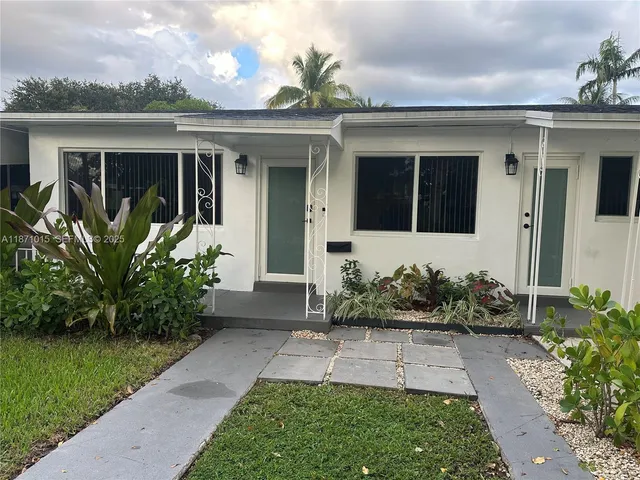 front view of a house with a yard