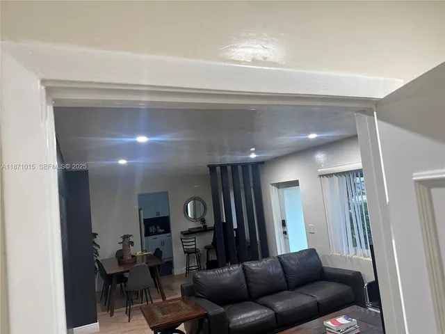 a lobby with painting on the wall and a potted plant