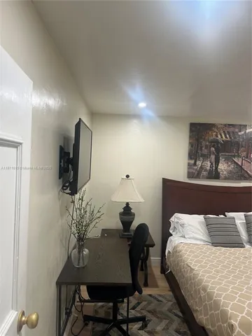 a lobby with painting on the wall and a potted plant