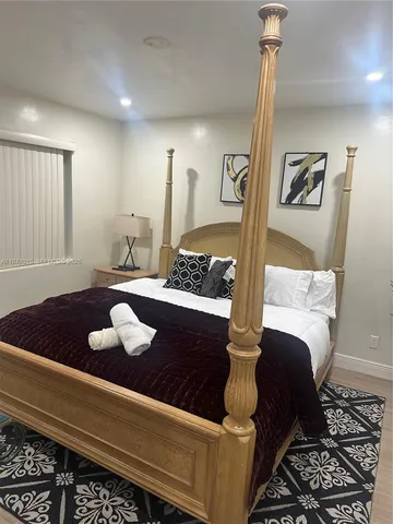a view of a patio with table and chairs with wooden floor and fence
