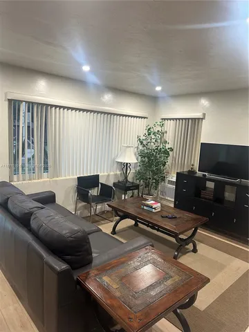 a view of a patio with table and chairs with wooden floor and fence
