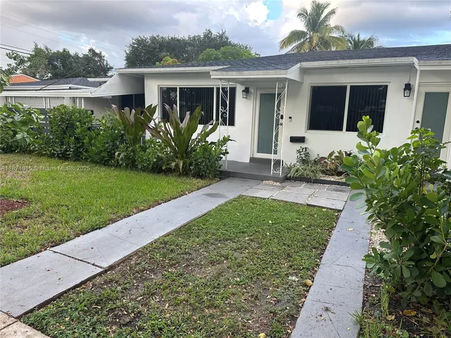 front view of a house with a yard