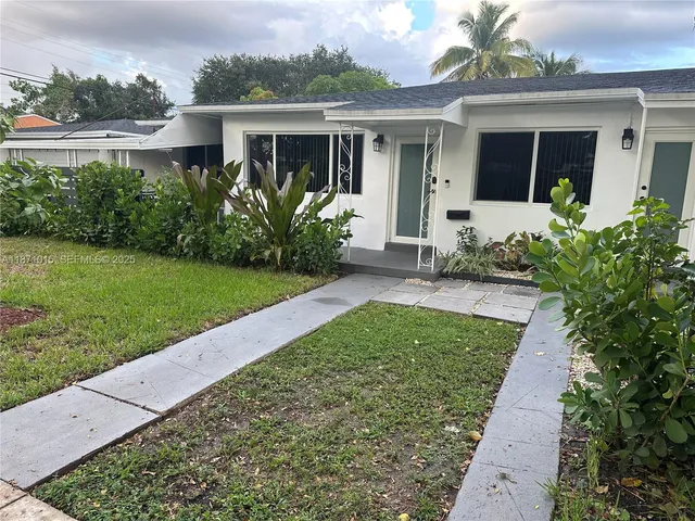 front view of a house with a yard
