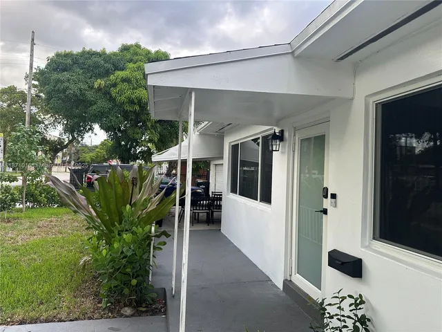 a view of a porch with plants and garden