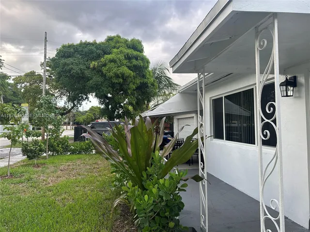 a view of a house with a tree