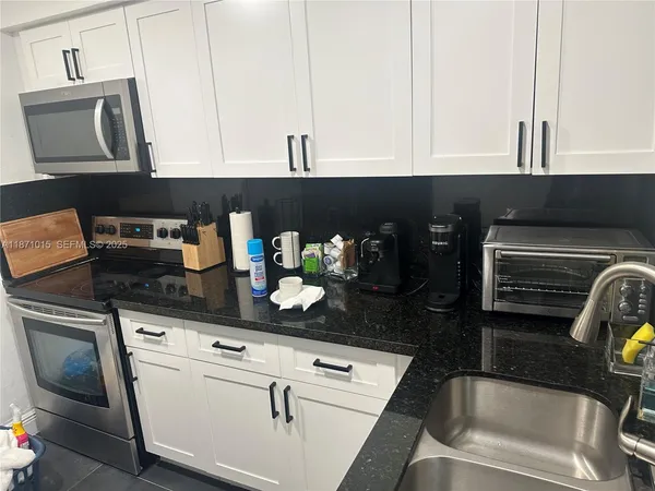 a kitchen with stainless steel appliances a refrigerator and cabinets