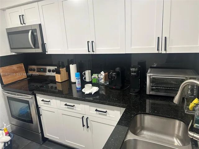a kitchen with stainless steel appliances a refrigerator and cabinets