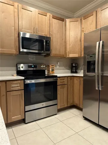 a kitchen with stainless steel appliances granite countertop a stove a microwave and a refrigerator