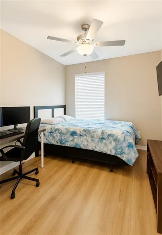 a bedroom with a bed and a desk