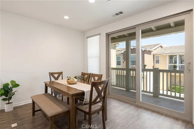 a dining room with furniture and wooden floor