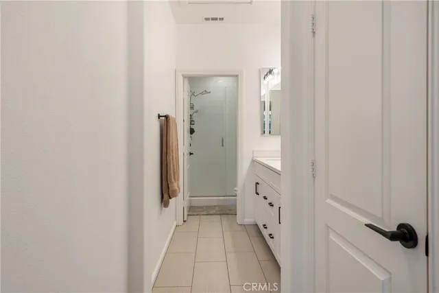 a bathroom with a double vanity sink mirror and shower