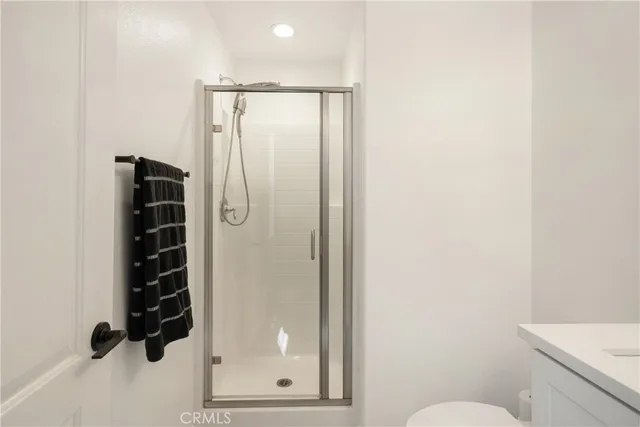 a bathroom with a sink mirror and toilet