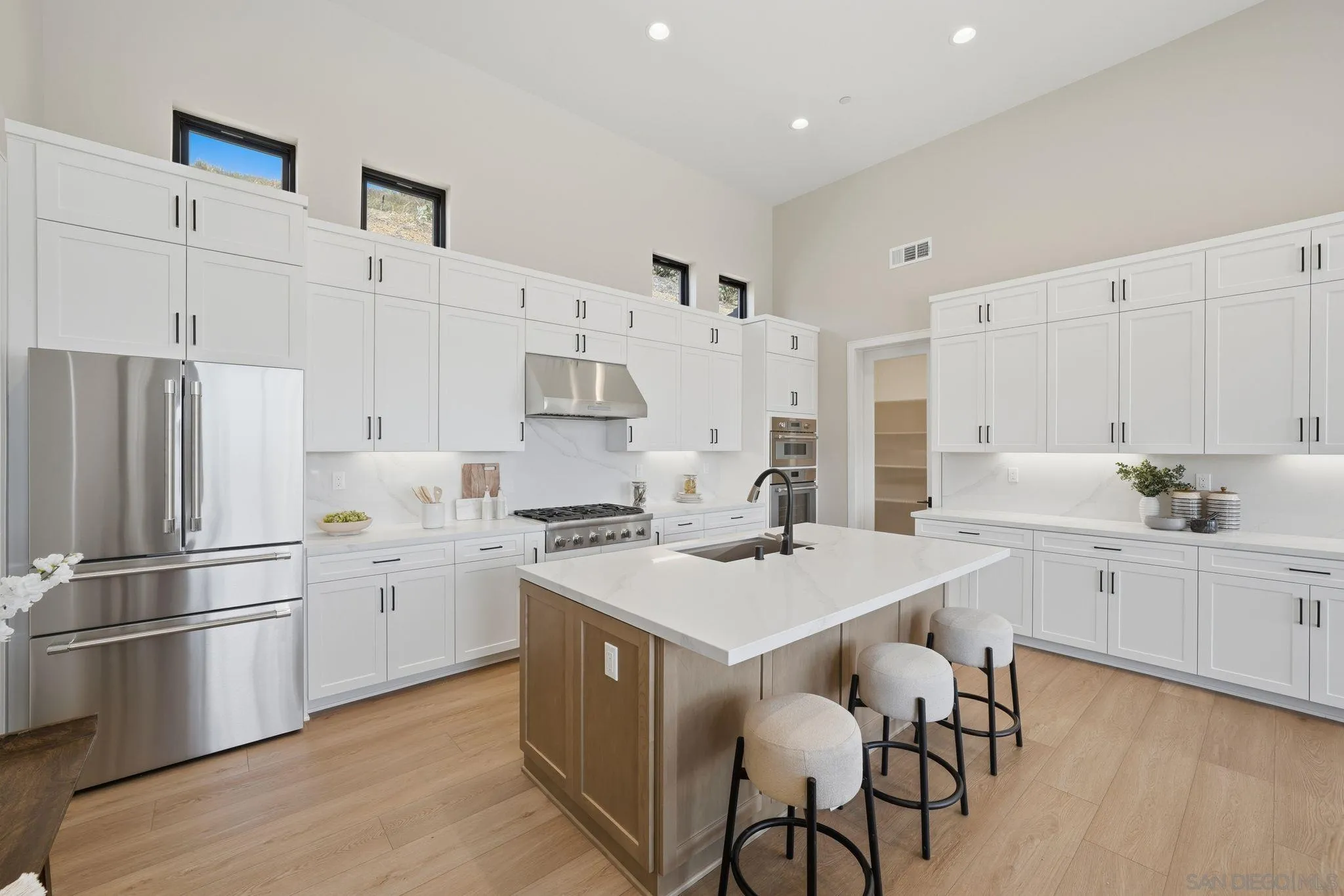 3916 Citrus Drive Fallbrook, CA 92028 - Photo 12 of 72 a kitchen that has a lot of white cabinets and stainless steel appliances