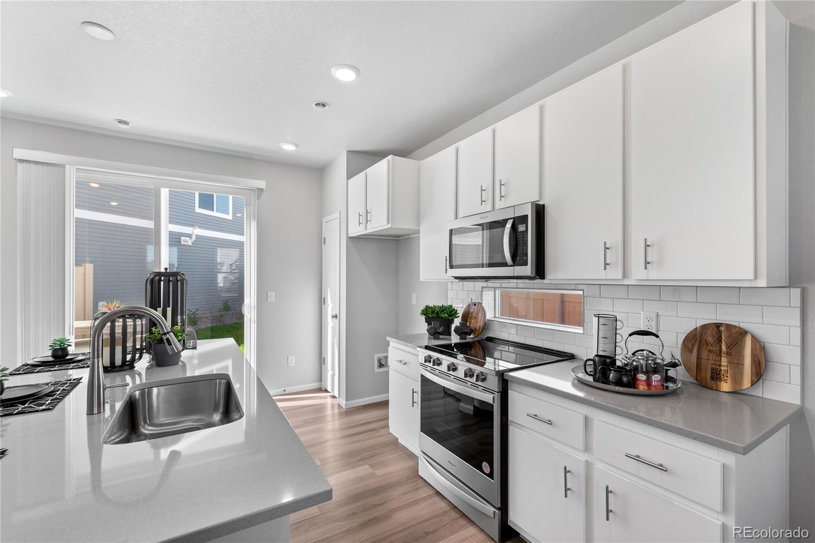 a kitchen with cabinets and stainless steel appliances