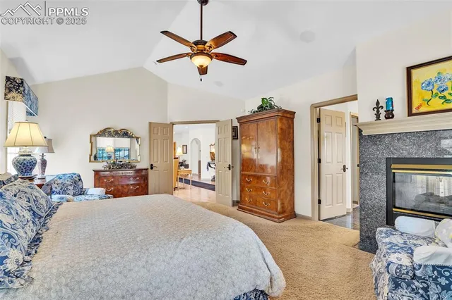 a bedroom with a bed chandelier and a window