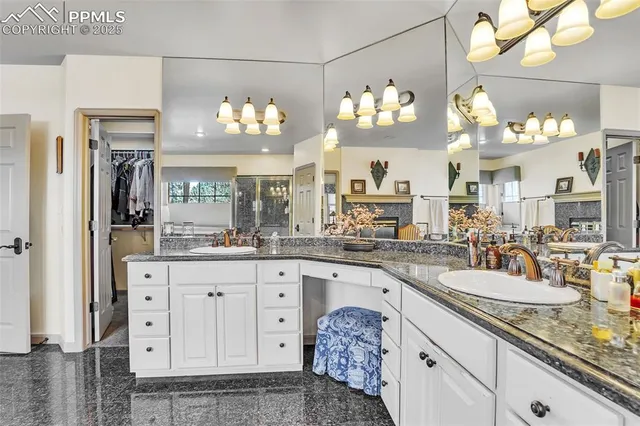 a kitchen with lots of counter top space and chandelier