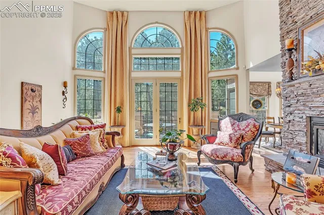 a living room with furniture and floor to ceiling windows