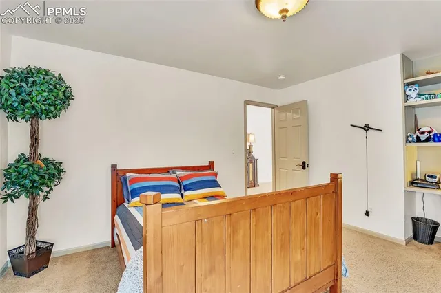 a bedroom with a bed and a potted plant