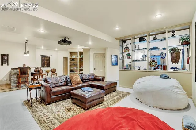a living room with furniture a rug and a flat screen tv
