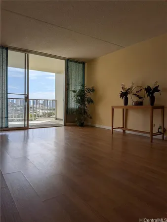a view of a hallway with wooden floor and a living room