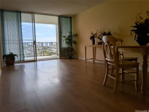 a dining room with furniture and wooden floor