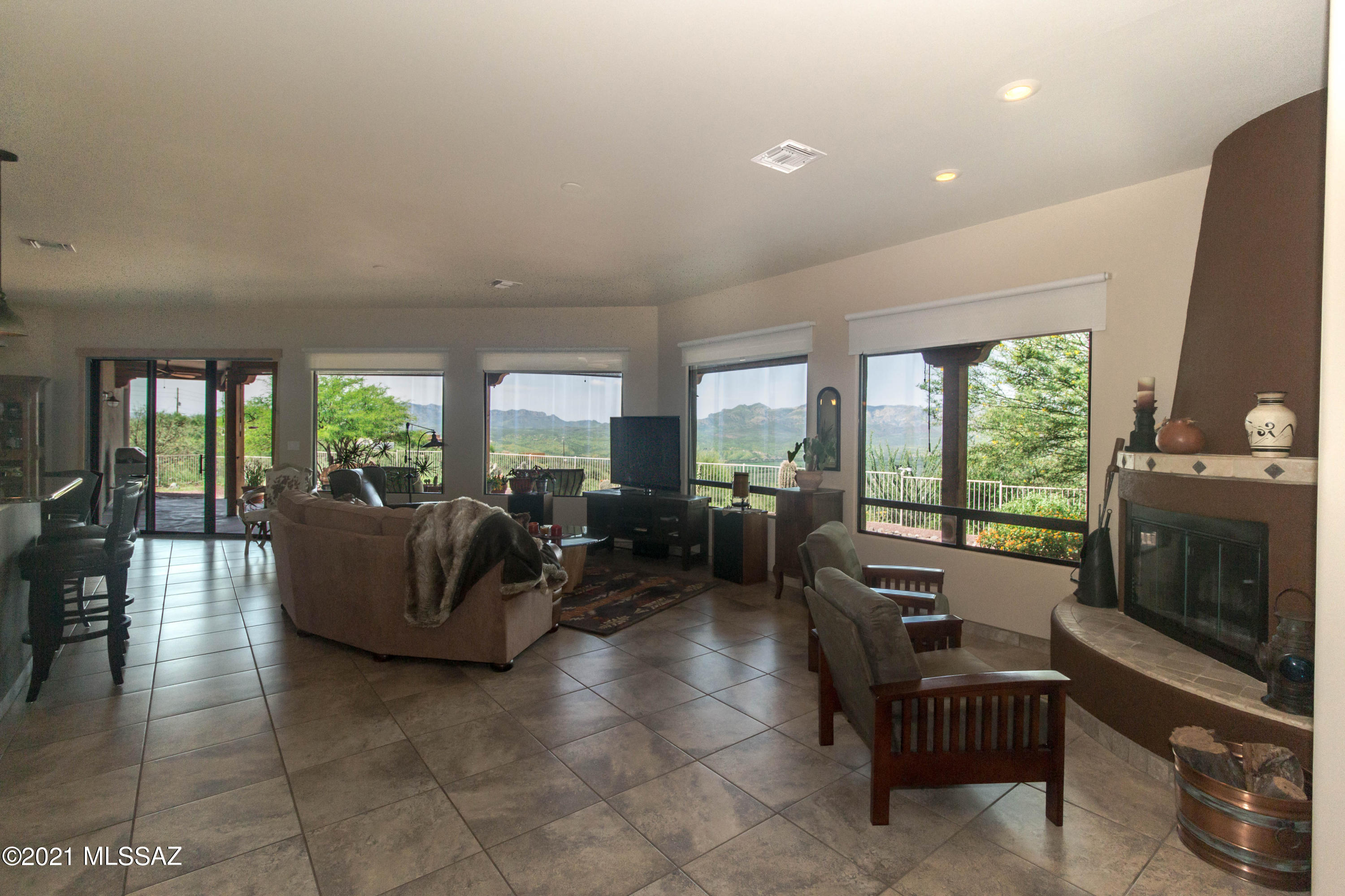1567 Camino Esturion Rio Rico, AZ 85648 - Photo 16 of 41 a living room with furniture large window and flat screen tv
