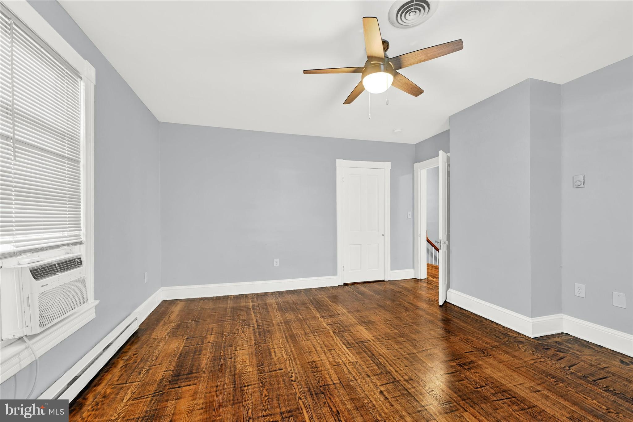 125 West Main Street Westminster, MD 21157 - Photo 12 of 31 an empty room with wooden floor fan and windows