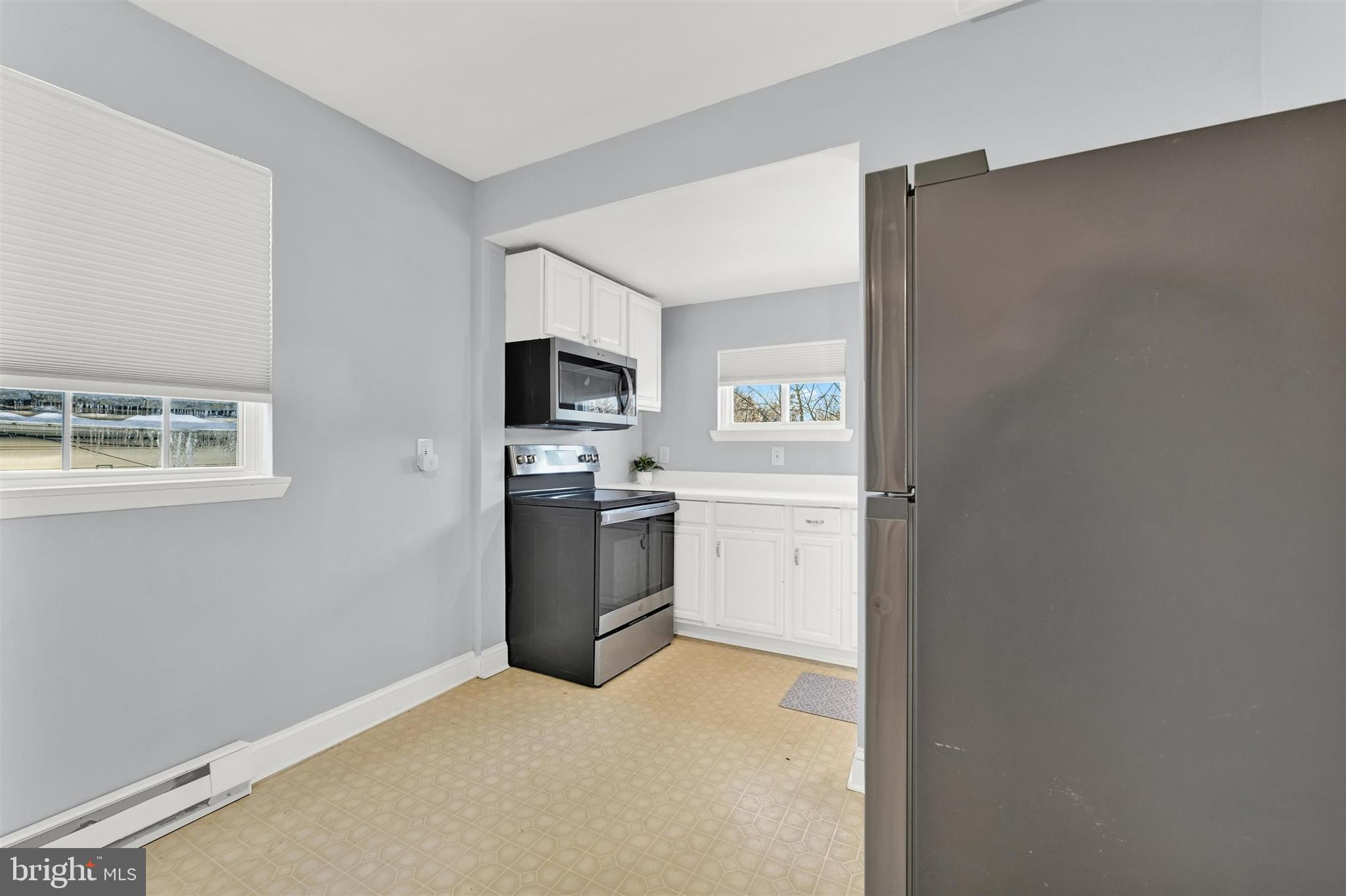 125 West Main Street Westminster, MD 21157 - Photo 15 of 31 a kitchen with a refrigerator a stove top oven and a sink