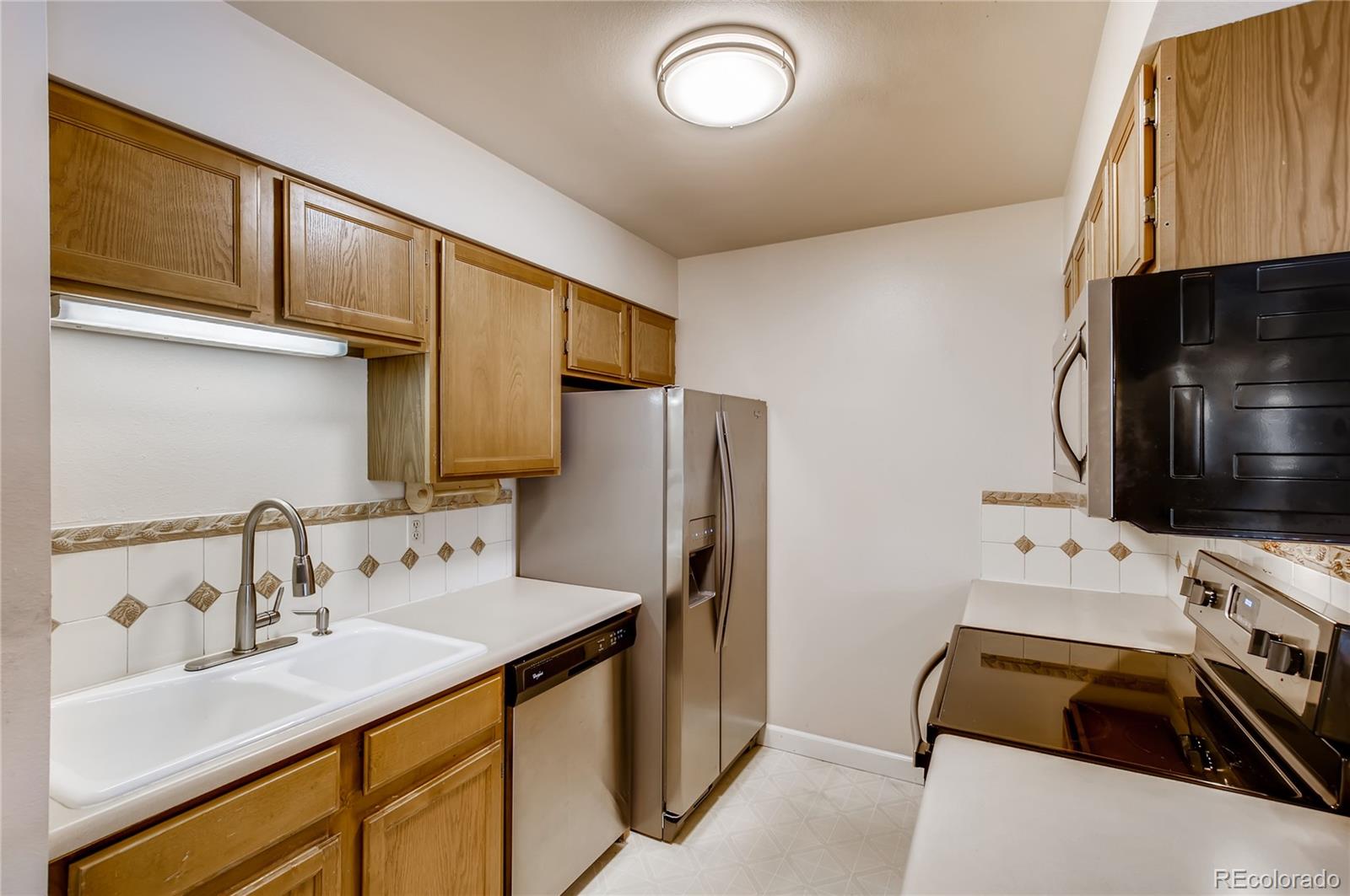 4682 White Rock Circle, Unit 9 Boulder, CO 80301 - Photo 4 of 12 a kitchen with stainless steel appliances a stove sink and refrigerator