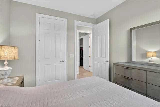 a bedroom with a bed and a mirror