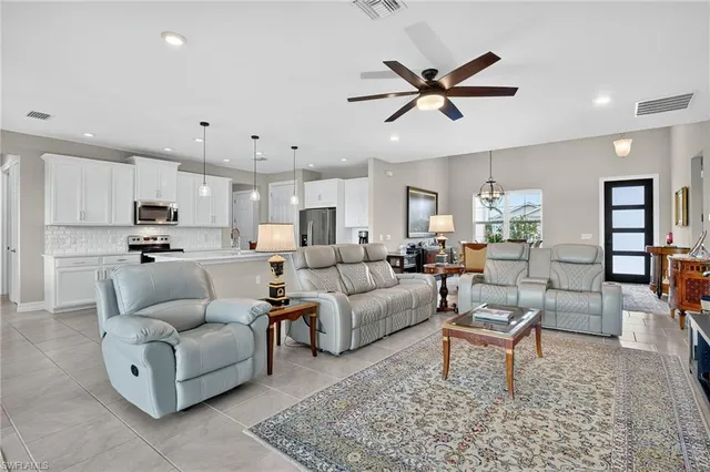 a living room with furniture and kitchen view