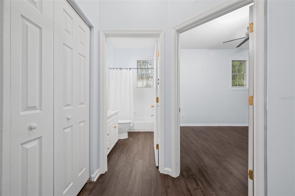 5213 Southwest 91 Terrace, Unit B Gainesville, FL 32608 - Photo 19 of 38 a view of a hallway with wooden floor