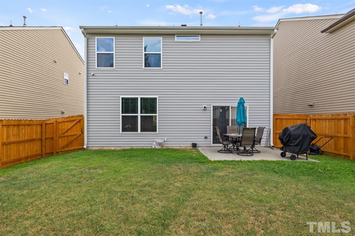 3529 Eastern Branch Road Raleigh, NC 27610 - Photo 24 of 24 a view of a backyard with sitting area and garage