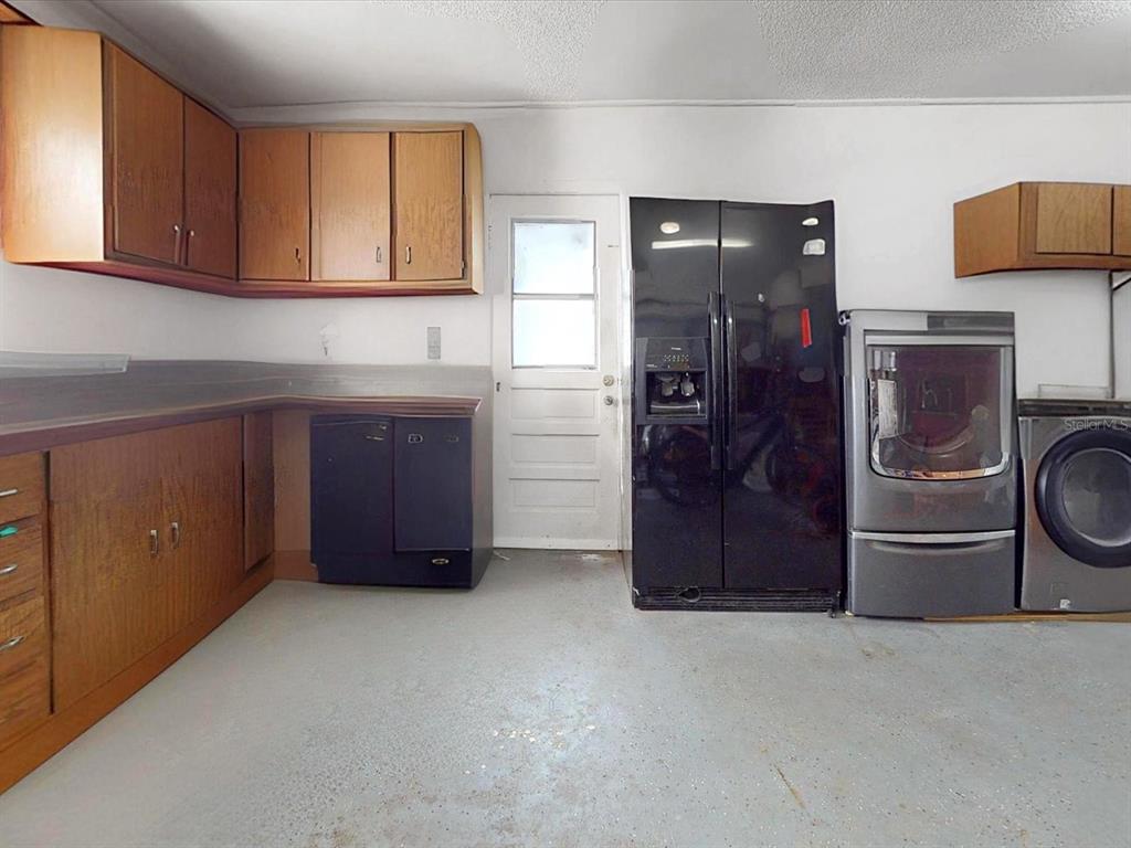 2615 Cecile Street Kissimmee, FL 34741 - Photo 25 of 30 a kitchen with a refrigerator and cabinets