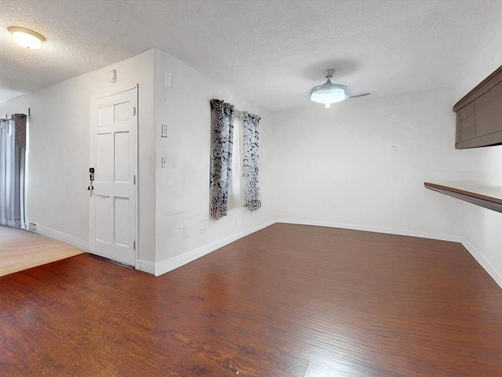 2615 Cecile Street Kissimmee, FL 34741 - Photo 6 of 30 a view of empty room with wooden floor and fan