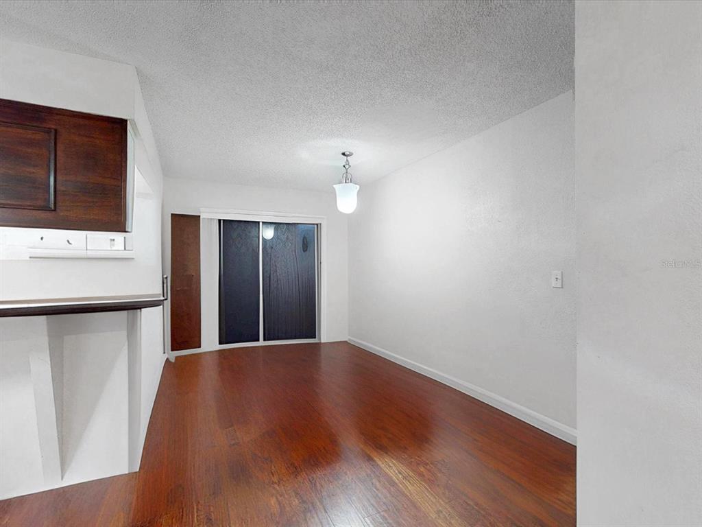 2615 Cecile Street Kissimmee, FL 34741 - Photo 10 of 30 a view of a kitchen with wooden floor and a refrigerator