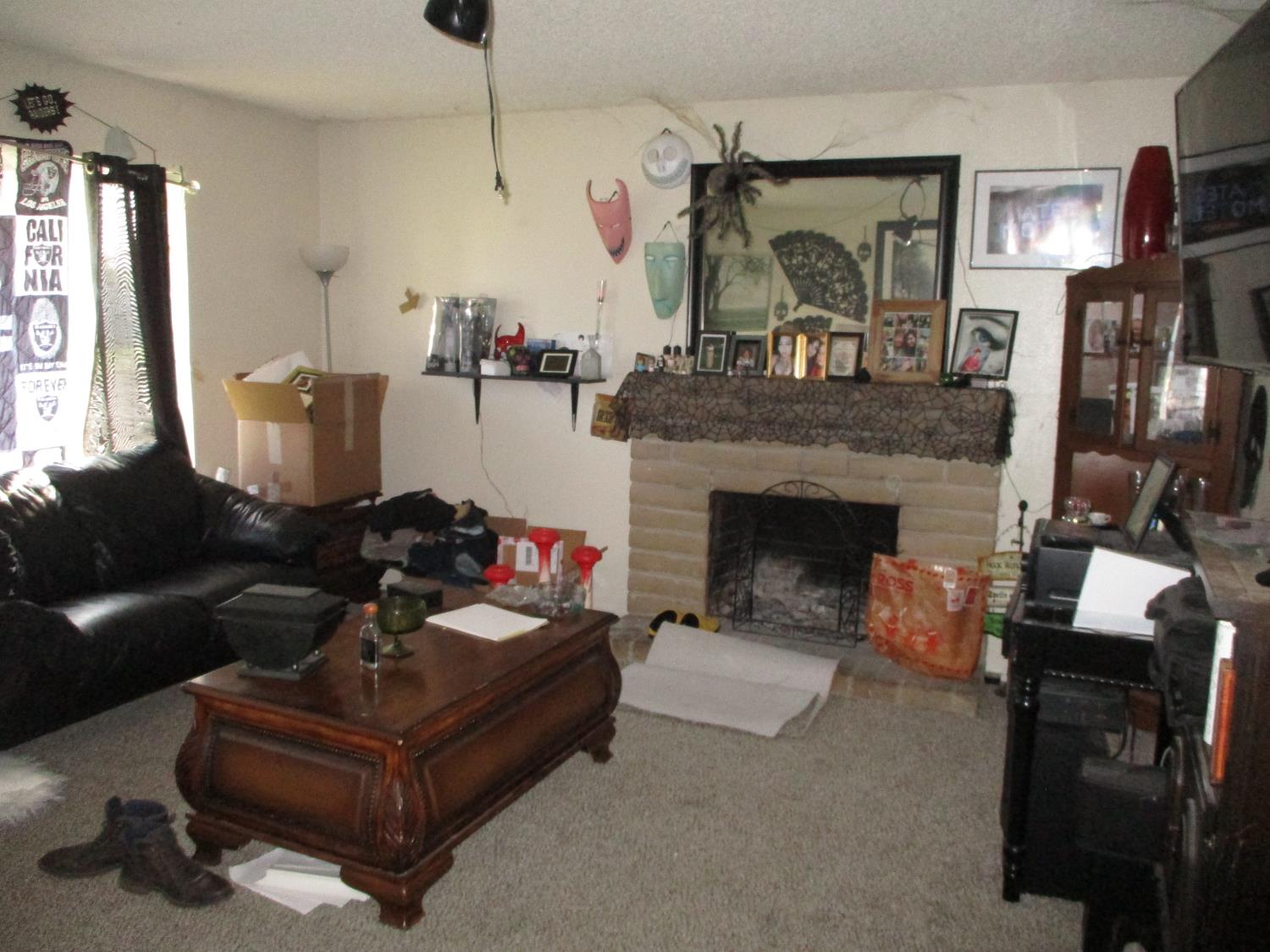 8437 Cherbourg Way Stockton, CA 95210 - Photo 4 of 28 a living room with furniture and a fireplace