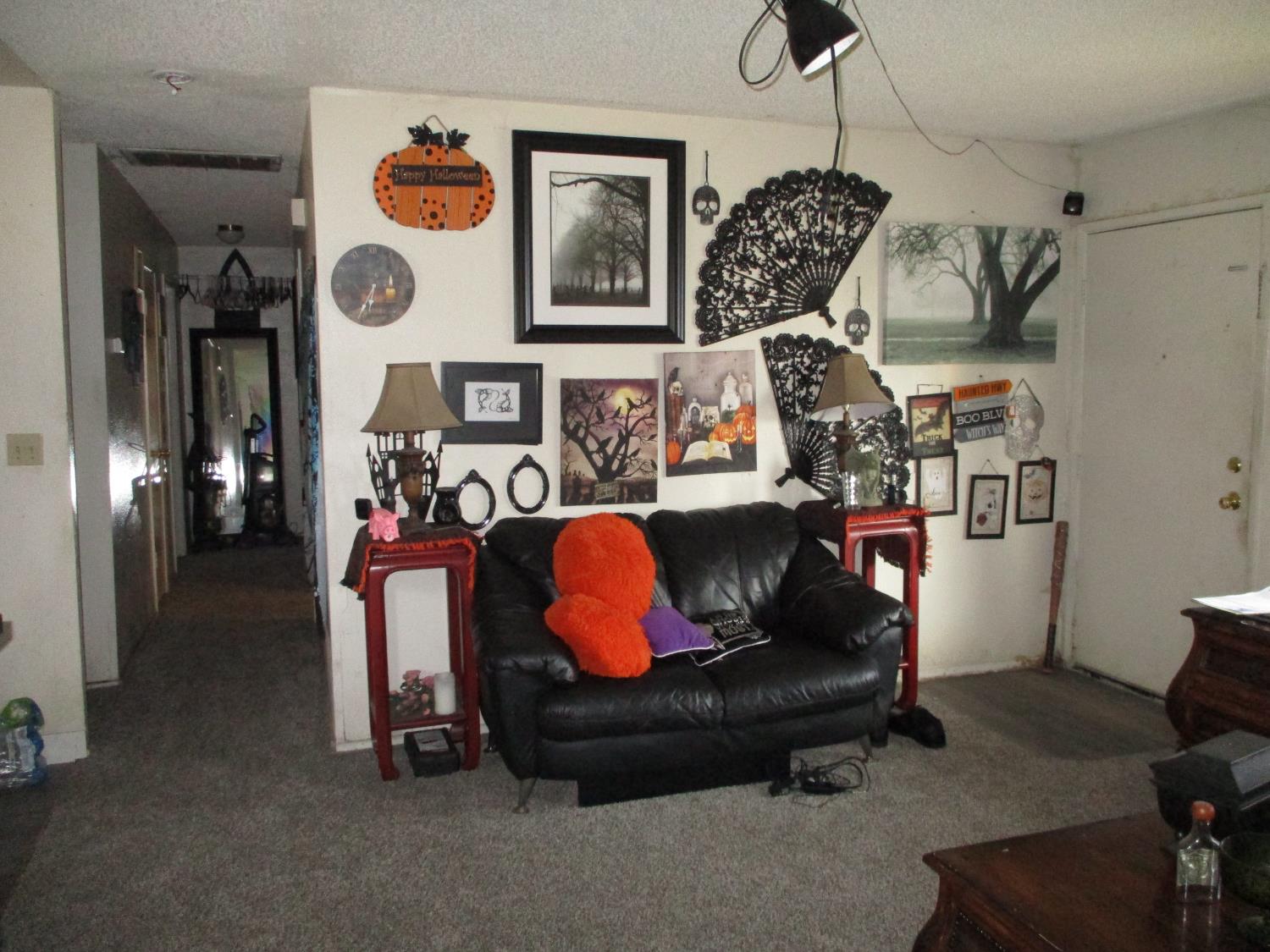 8437 Cherbourg Way Stockton, CA 95210 - Photo 6 of 28 a living room with furniture and a chandelier